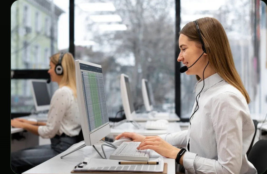 Customer service team wearing headsets at workstations